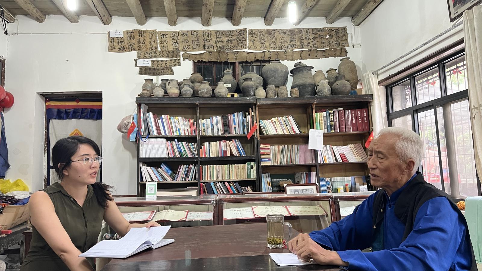 A man sits across a table from Yanshuo Zhang